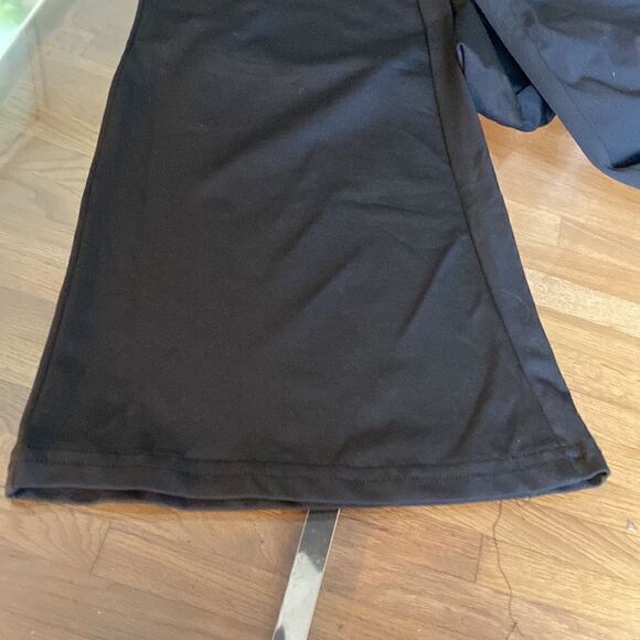 Put on black flare pants with cut out waste accent and silver accessory. Stretch - Picture 4 of 11